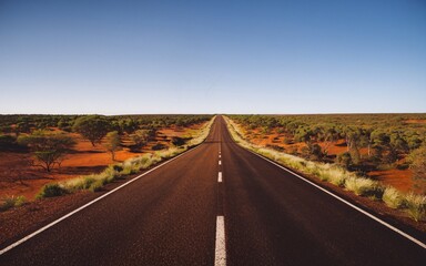 Fototapeta premium Australian Outback Road with Space for Text Under a Clear Blue Sky