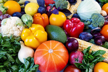 Colorful assortment of fresh fruits and vegetables. A vibrant display of fresh fruits and vegetables, including bell peppers, cauliflower, broccoli, corn, and various other produce.