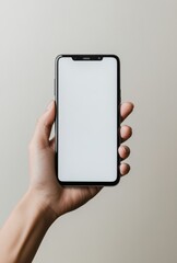 Hand holding a smartphone with a blank screen