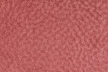 Faux fur texture with wavy effect, fluffy velours red fabric or cloth, upholstery textile