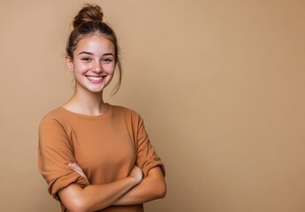 Obraz premium happy, smiling young woman standing with her arms crossed, looking at the camera