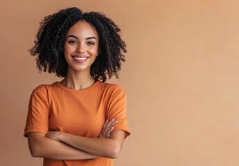 Fototapeta premium happy, smiling young woman standing with her arms crossed, looking at the camera