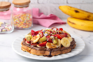Fruit waffles, bananas with chocolate sauce, strawberries, chocolate chips, handmade Turkish...