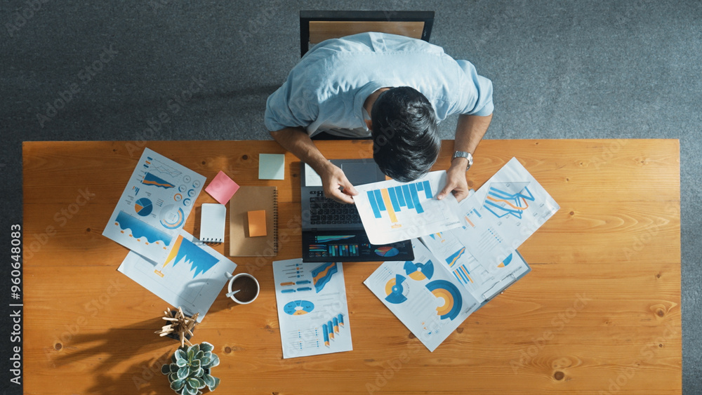 Poster top aerial view of manager working on laptop while looking at data analysis. leader compare financia
