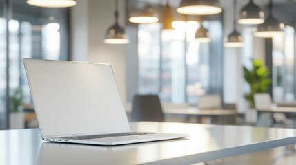 Naklejka premium white laptop on a sleek desk in a modern office
