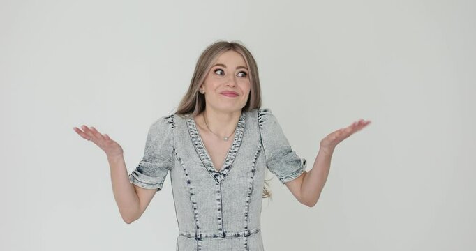 Blonde woman spreads hands in gesture of confusion. Lady shows inability to explain situation unfolding with expression of genuine puzzlement