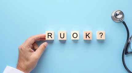 R U OK wooden cube block for health check up on blue background.