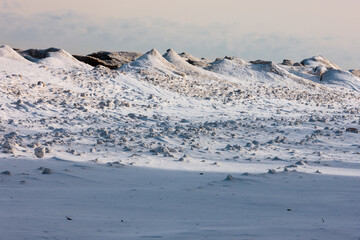 The frozen shoreline filled with ice volcanoes along Lake Michigan at Harrington Beach State Park,...