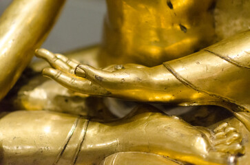 buddha hands, Buddha Shakyamuni, golden sculpture preserved at the MAO oriental art museum in Turin. the Buddha in his lotus flower meditative position, with detail of the hands.