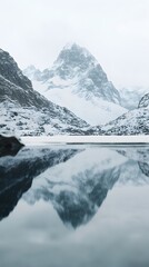 Fototapeta premium A cinematic still of snow-covered mountains reflecting in the calm waters, creating an ethereal and serene atmosphere