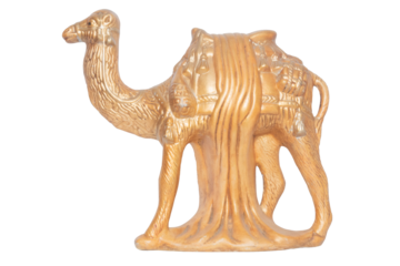 A golden porcelain camel isolated on a white background. Animal theme. Figurine of a nativity scene.