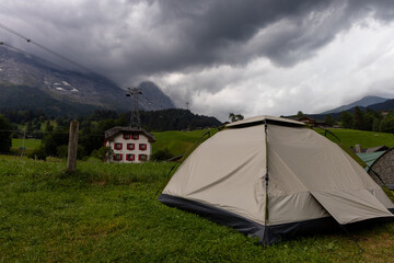 Tent with dark storm clouds approaching, mountain camping in bad weather