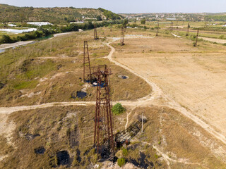 Old rusty oil well pump jack field in Albaina, Aerial Drone Footage in sunny day. Tiny Homemade Oil...