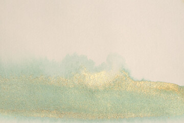 Gold glitter grain metallic ink watercolor smear brushstroke stain blot on beige neutral background...