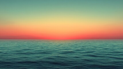 Fototapeta premium The sun dips below the horizon, casting warm colors across the tranquil ocean surface at dusk