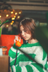 retro, cute girl teen talking on old orange vintage phone with dialer
