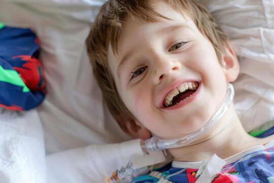 Bright smile of a young boy with a tracheostomy tube in a cozy hospital bed during a sunny afternoon