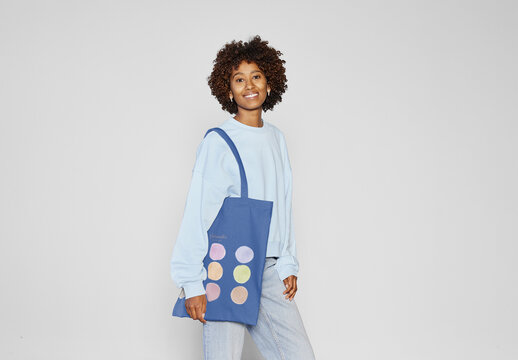 Mockup Of Woman With Afro Hair Holding Tote Bag Over Her Shoulder. 