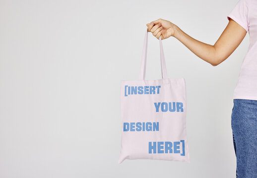 Mockup Of hand Holding Customizable Tote Bag. 
