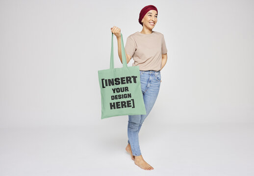 Mockup Of Smiling Arab Woman With Hijab Holding Tote Bag.