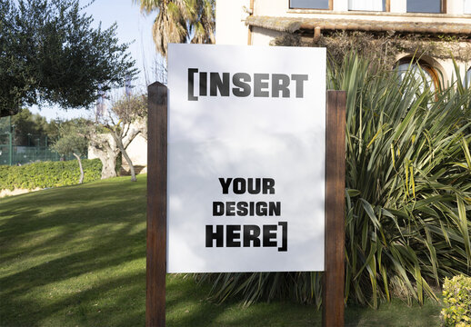 Mockup Of Sign Mounted On Wooden Poles Outside Of A House. Real State signage