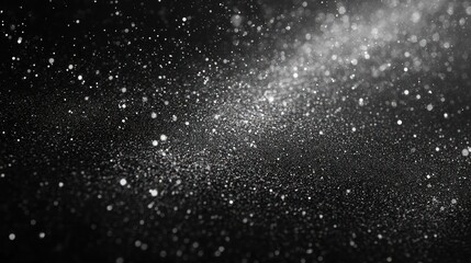 Obraz premium A mesmerizing display of sparkling dust particles against a dark background, creating a magical atmosphere.