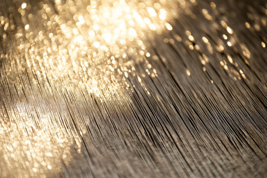 A bright textured surface with a subtle, linear texture, featuring fine, parallel lines that catch and reflect light dynamically.