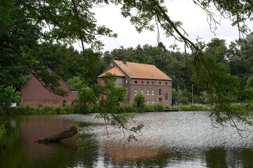 Fototapeta premium Landschaft im Sommer mit Gebäude an einem See