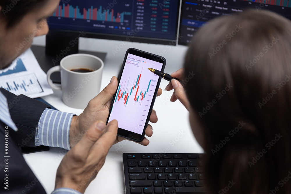 Poster cropped with focusing on phone with hand pointing with discussing dynamic stock market in two busine