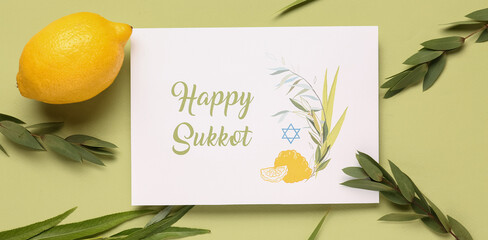 Four species (lulav, hadas, arava, etrog) and greeting card with text HAPPY SUKKOT on green...
