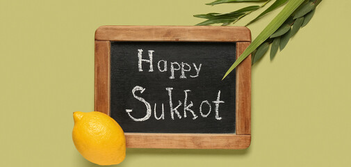 Four species (lulav, hadas, arava, etrog) and chalkboard with text HAPPY SUKKOT on green background