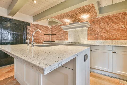 Modern kitchen with stylish brick wall elements
