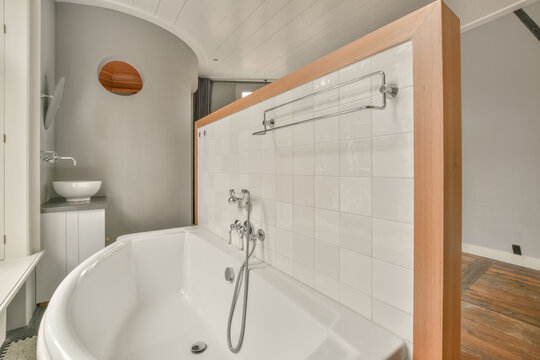 Modern bathroom interior with white bathtub and fixtures
