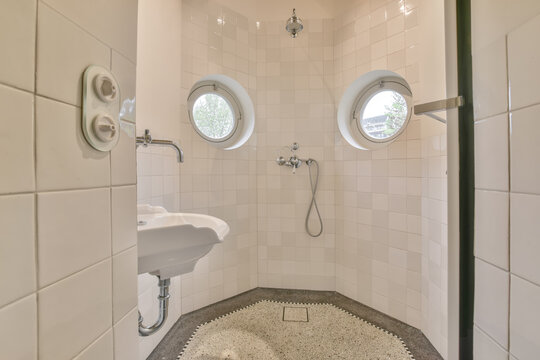 Bright and clean corner shower with circular windows