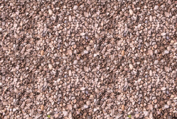 brown gravel stone background, fine stone closeup loose texture