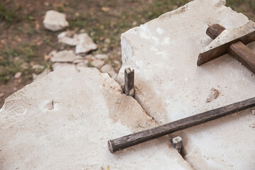 mason's tool iron chisel and hammer on stone background