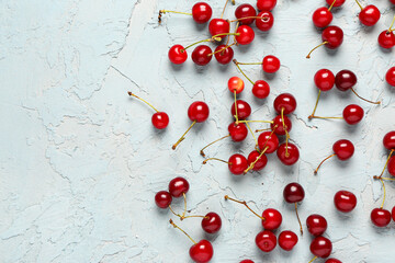 Many red sweet cherries on blue background