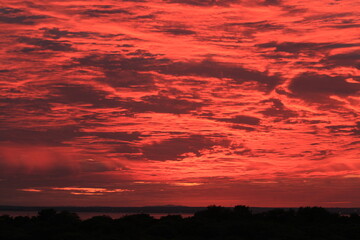 A beautiful red sunrise on the shores of the lake