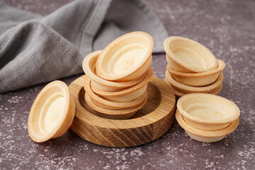 Bowl with homemade tartlets on grey background