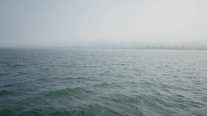 Background video of a calm sea on a misty day