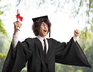 Happy graduate student holding diploma