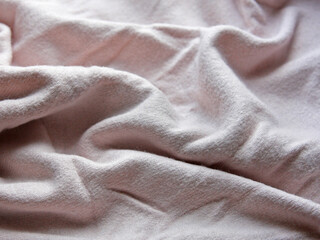 A knitted thing is a plaid, a blanket made of wool, knitwear for comfort and warmth in cold weather. Texture, pattern and background with fabric and drapery. Hygge style idea