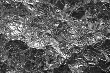 Processed collage of shiny metal silver gray foil crumpled packaging material texture