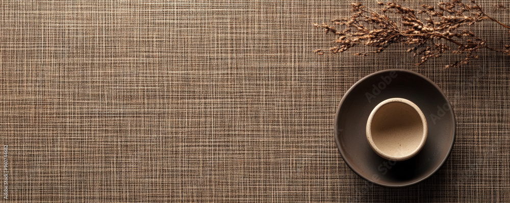 Aufkleber a brown textured surface with a fine, crosshatched pattern, creating a woven effect that adds sophis