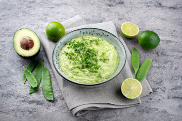 Traditional exotic spring dip with avocado and roasted vegetables served as close-up in a Nordic...