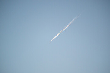 Contrail / chemtrail behind a plane high in sky