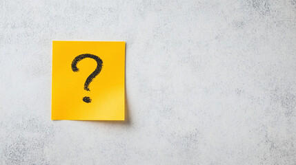 Question Mark Sticker on Yellow Sticky Note - against an isolated grey concrete background with Copy space.