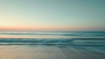 Obraz premium Tranquil ocean and clear sky during sunset with prolonged exposure, horizontal perspective.