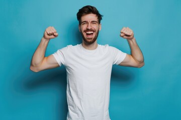 Fototapeta premium A person standing with arms up, wearing a white t-shirt