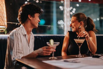 A young couple sharing a joyful moment during a vibrant night out at a stylish bar, enjoying cocktails and laughter.